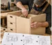 Assembling a flat-pack plywood cabinet with a screwdriver and a printed guide