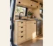 Finished plywood campervan kitchen with sink, drawers and fridge